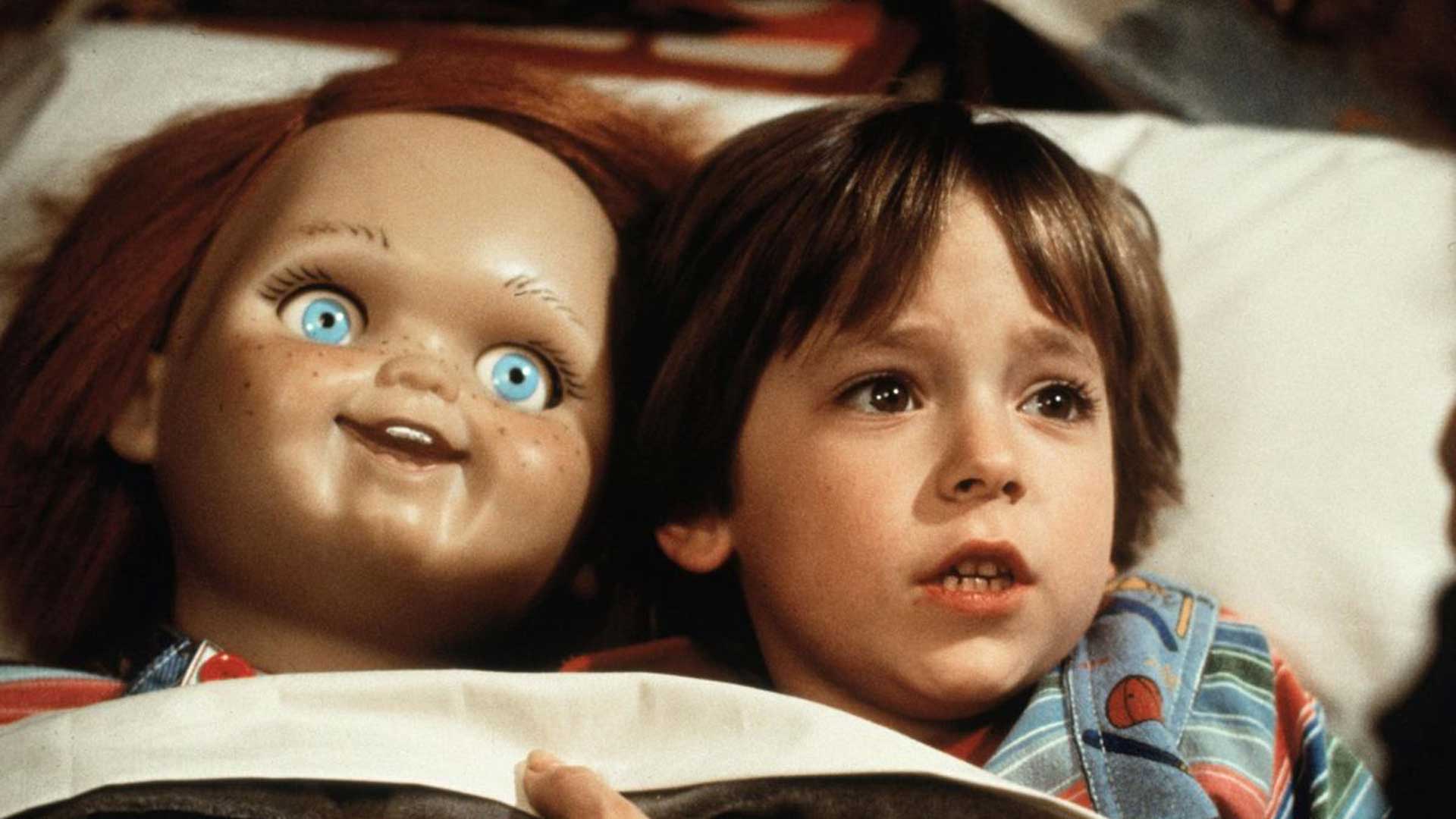 عروسک ترسناک چاکی در کنار بچه روی بالشت در فیلم بازی بچه