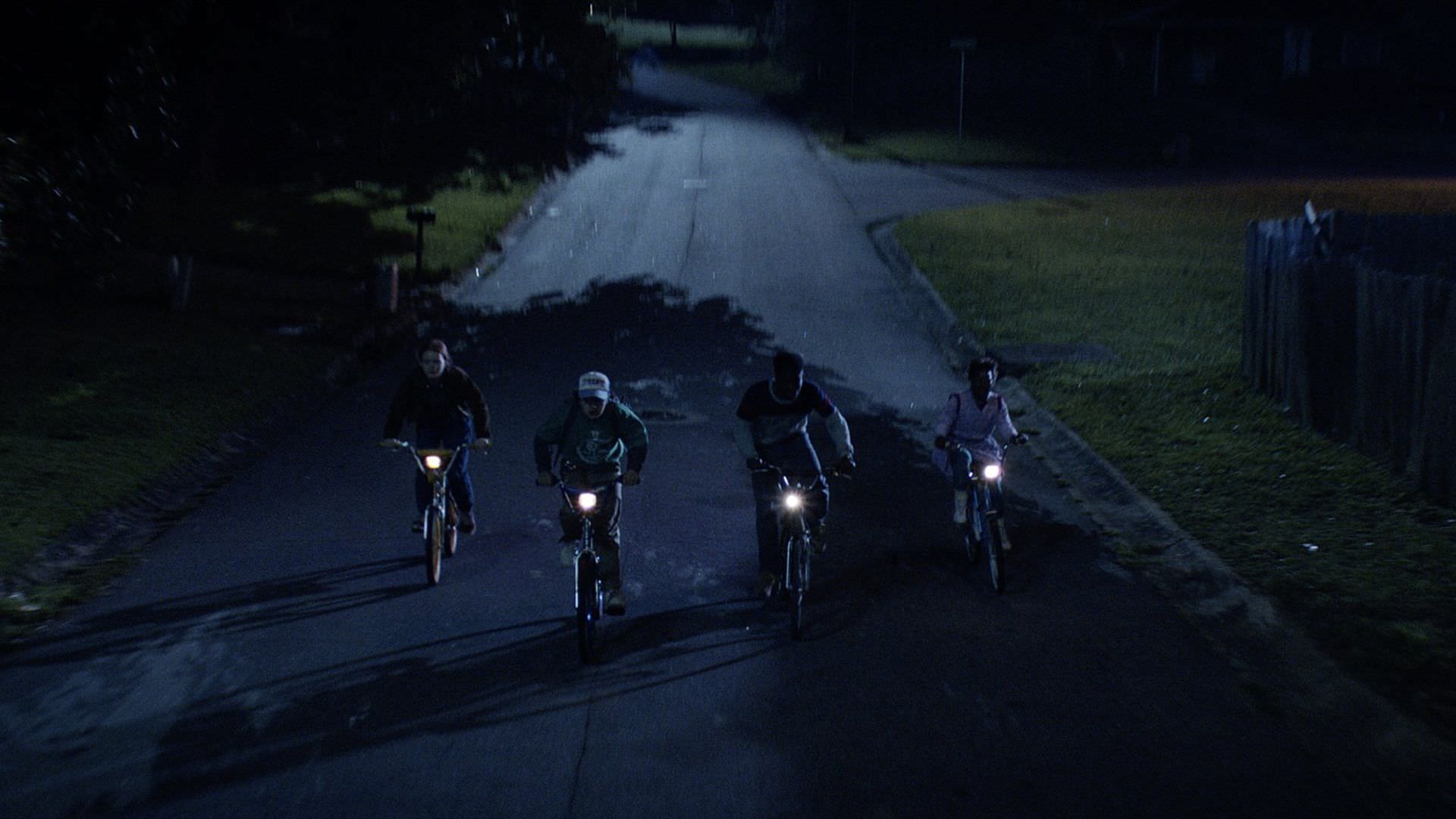 شخصیت‌های فصل چهارم سریال Stranger Things در حال دورچرخه سواری در شب در هاوکینز