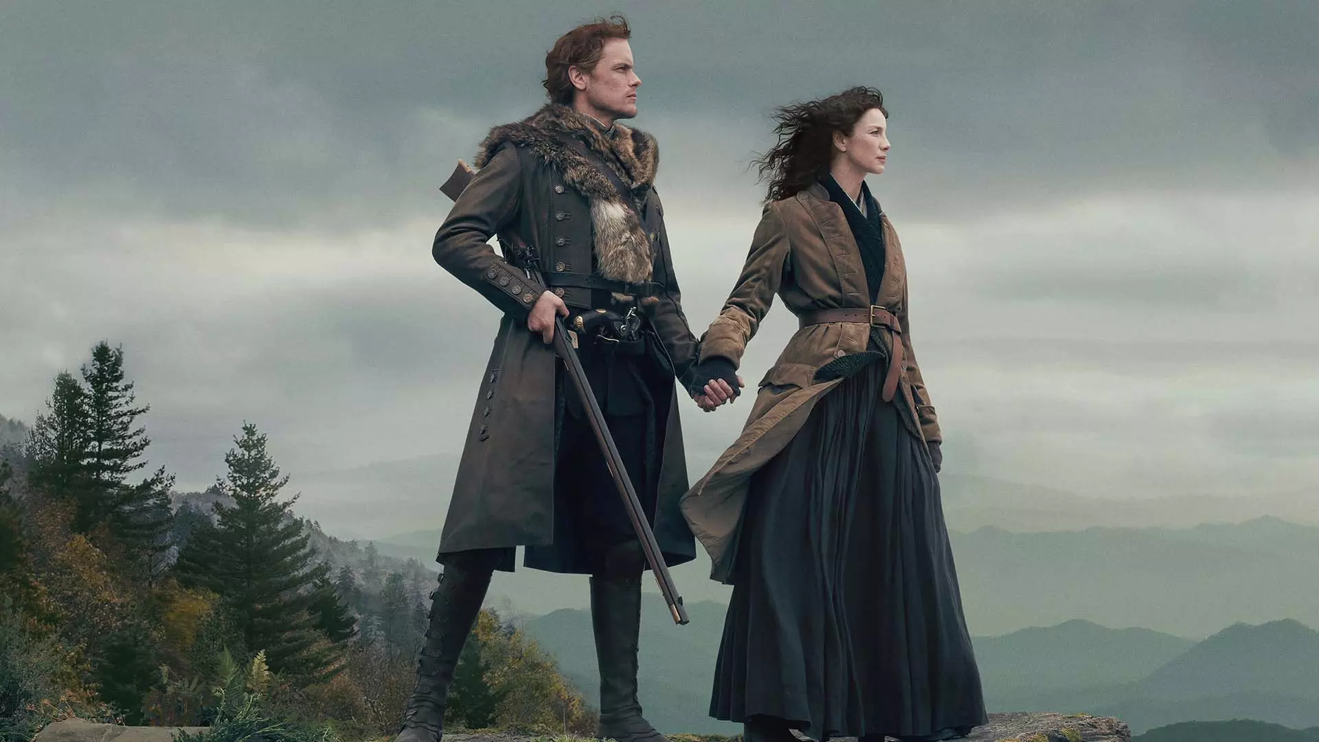 دو شخصیت اصلی سریال Outlander با یک تفنگ کنار هم ایستاده بودند