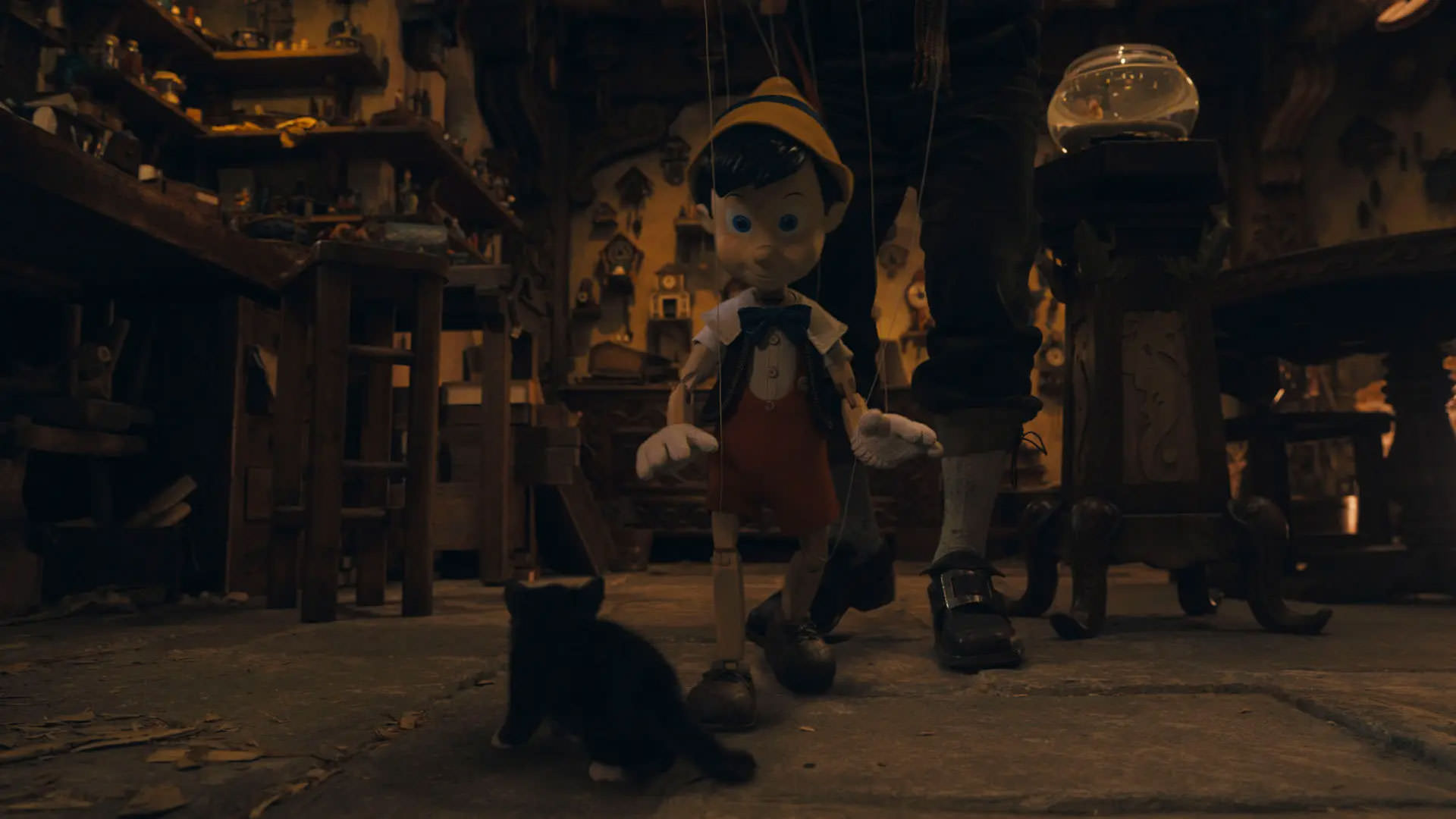 پینوکیو که توسط پدر ژپتو کنترل می‌شود در حال حرکت به سمت فیگارو گربه‌ی ژپتو در صحنه‌ای از فیلم پینوکیو به کارگردانی رابرت زمکیس