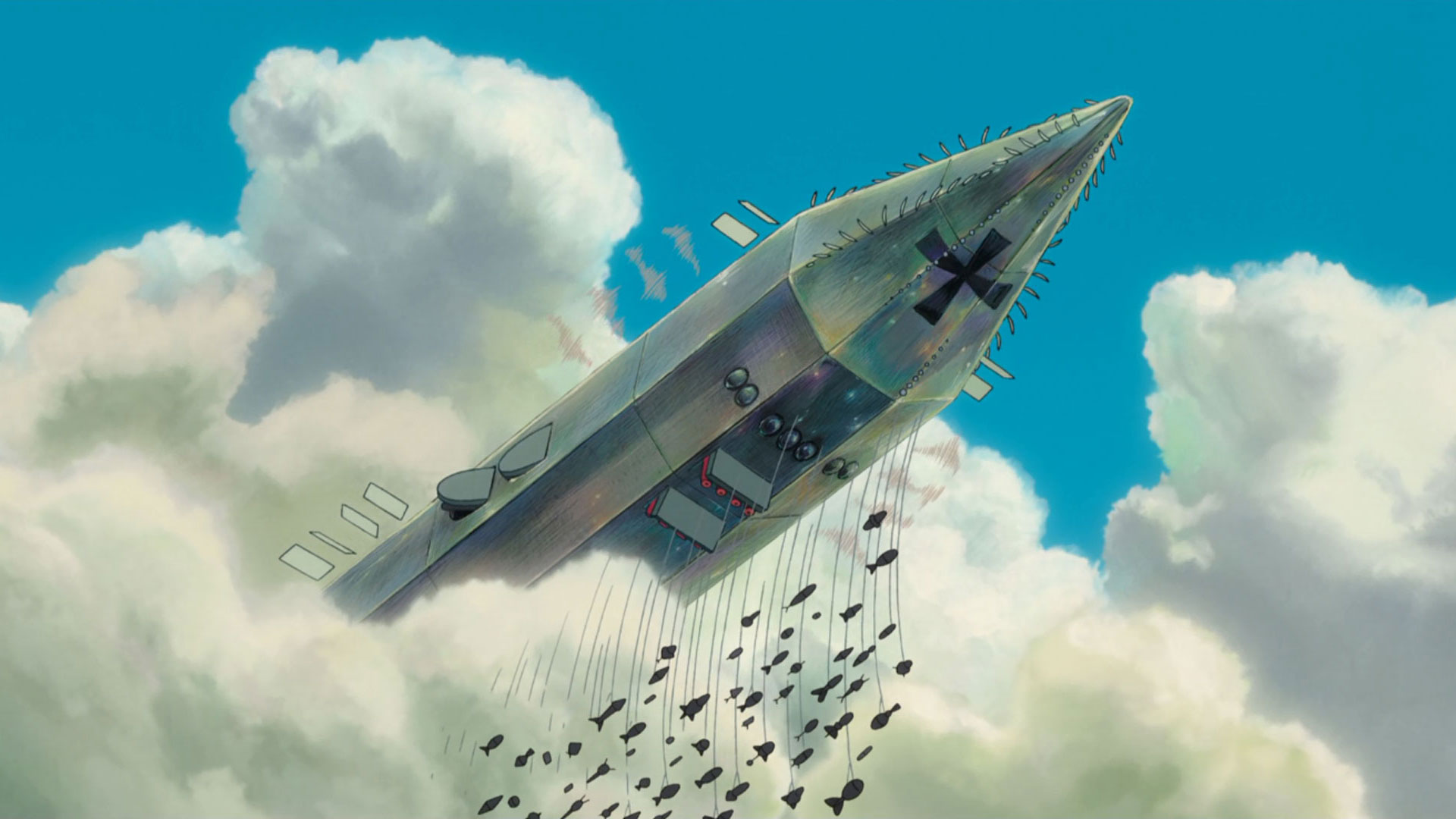 یک هواپیمای آهنین بزرگ با بمب‌هایی که به آن آویزان‌اند از میان ابرها ظاهر می‌شود در نمایی از انیمه باد برمی‌خیزد به کارگردانی هایائو میازاکی