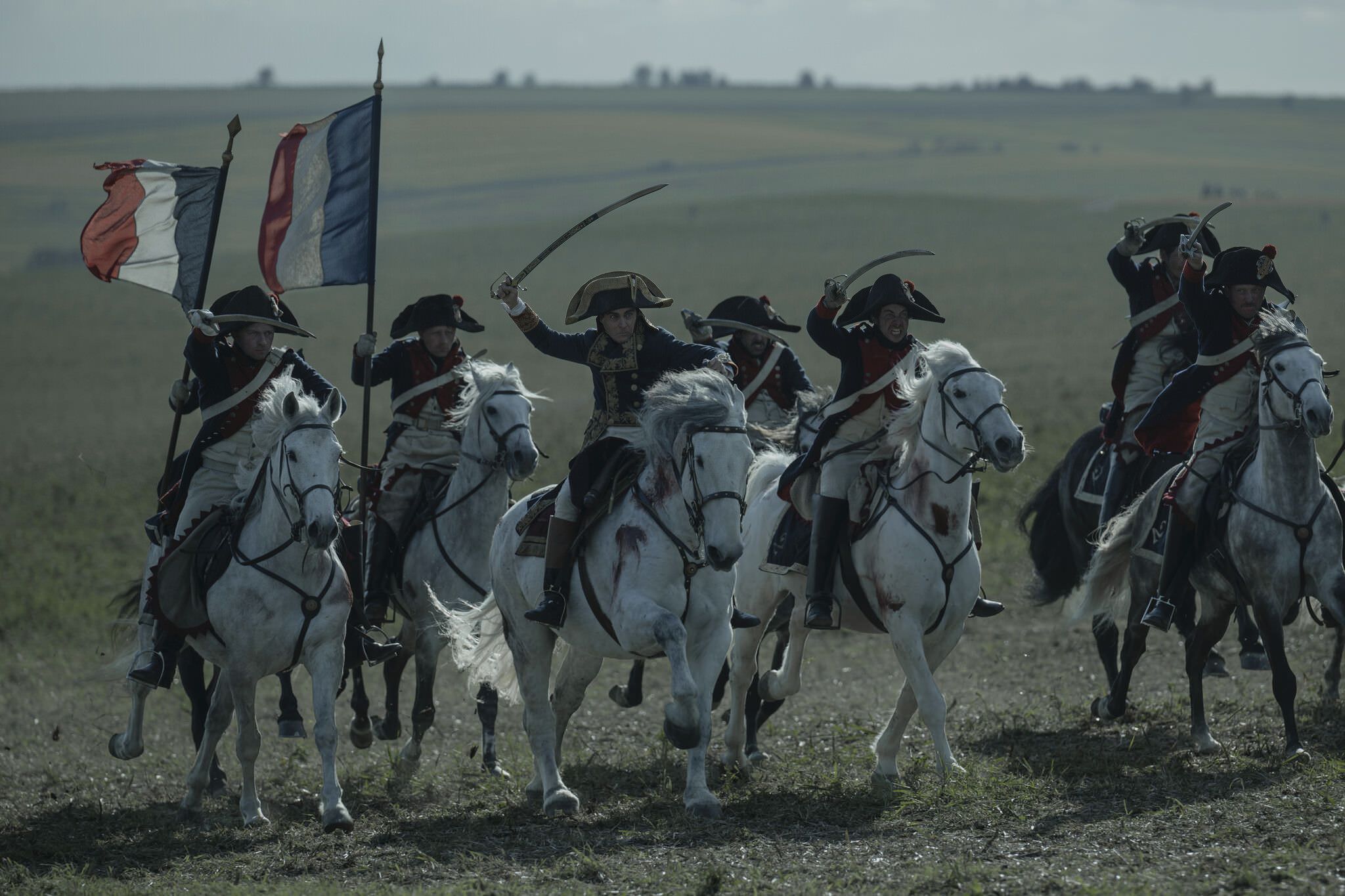 واکین فینیکس در نقش ناپلئون در حال سوارکاری درکنار نیروهایش در فیلم Napoleon ریدلی اسکات