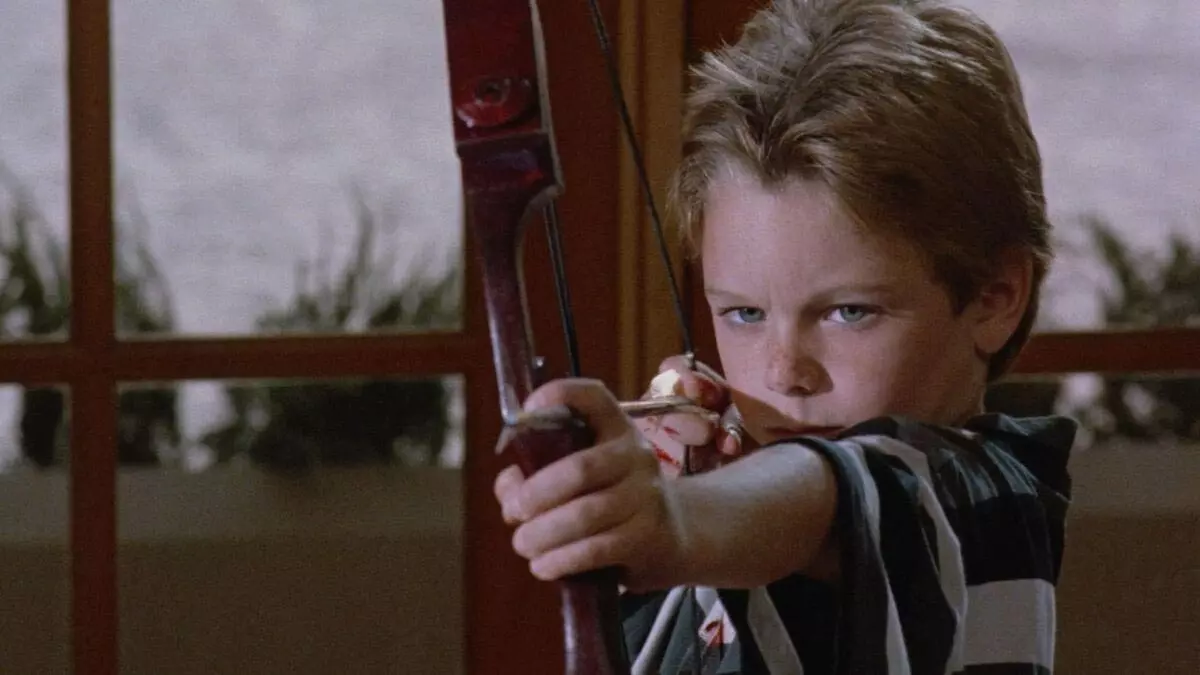 A boy named Mikey shooting a bow in the movie Mikey