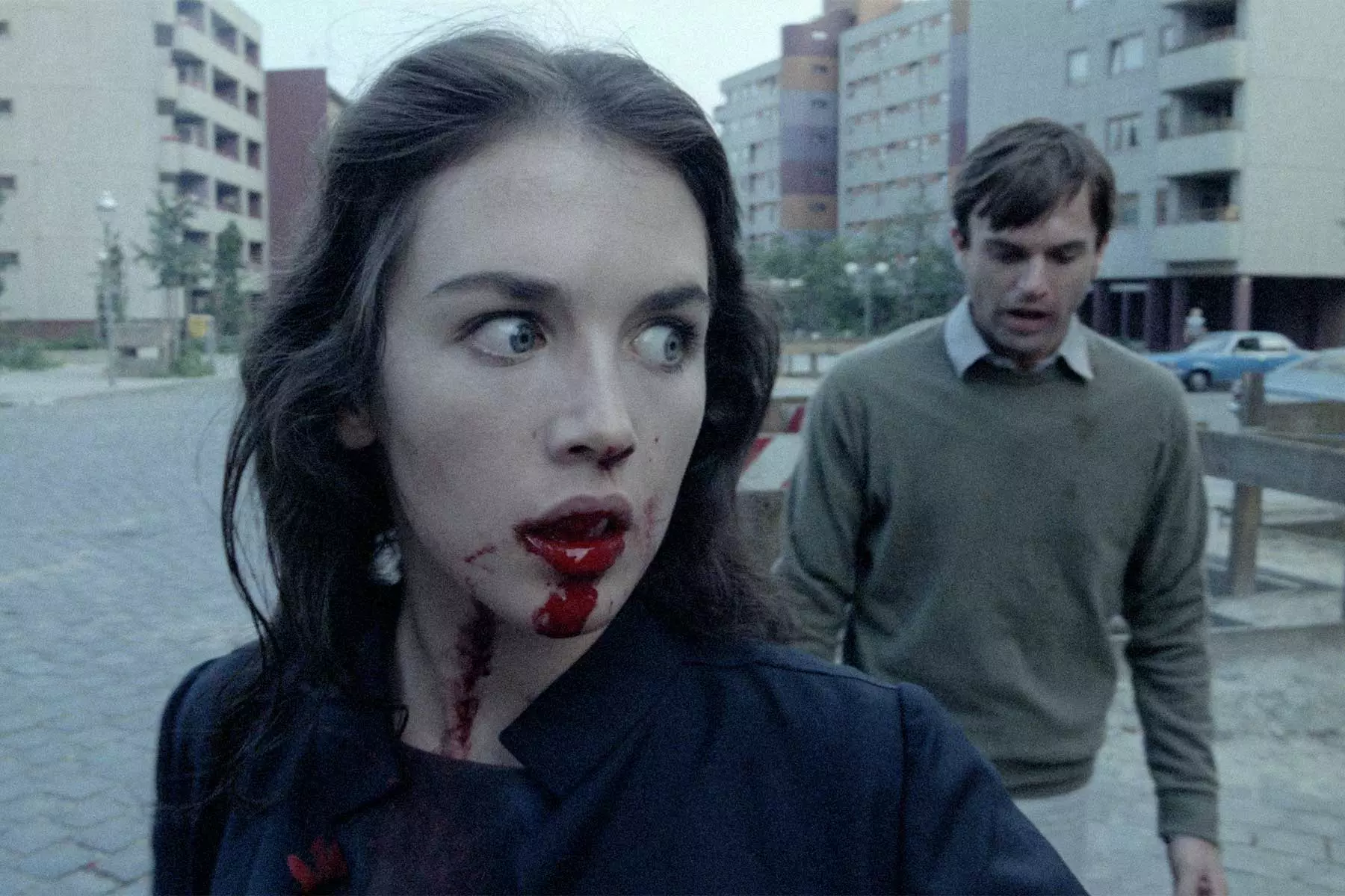 A scene from the movie Taskere featuring Isabelle Ajani with a bloody mouth