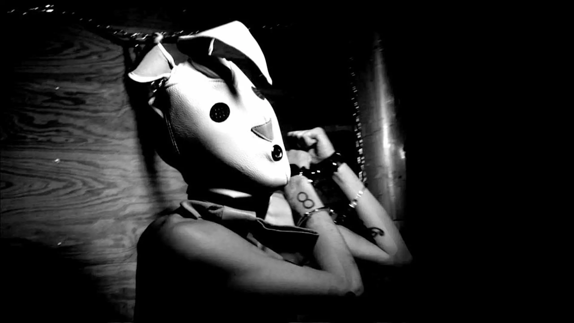 A woman with a rabbit mask and chained hands in the movie Bunny Game