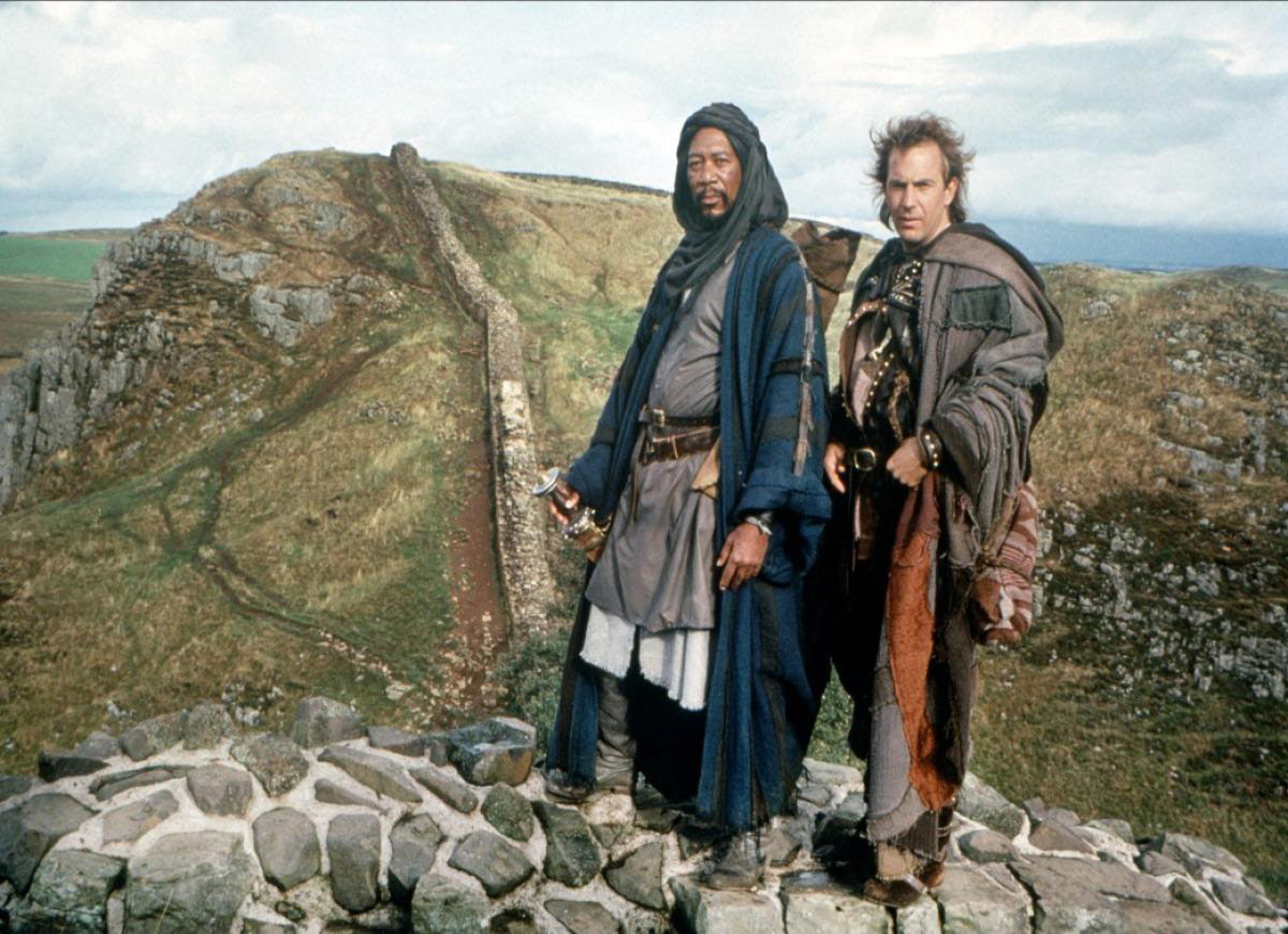 مورگان فریمن در نقش عظیم در کنار کوین کاستنر در نقش رابین هود ایستاده روی دیوار سنگی