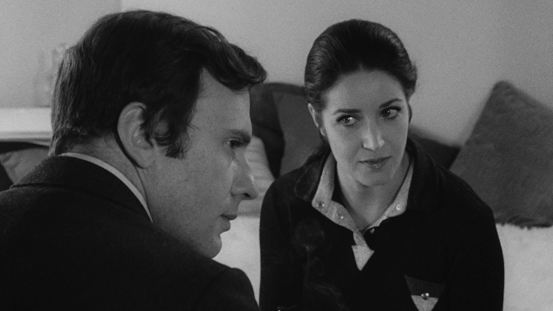 فرانسوا فابیان در صحنه ای سیاه و سفید از فیلم Ma nuit chez Maud به کارگردانی اریک رومر در مقابل ژان لوئی ترنتینیان نشسته است.